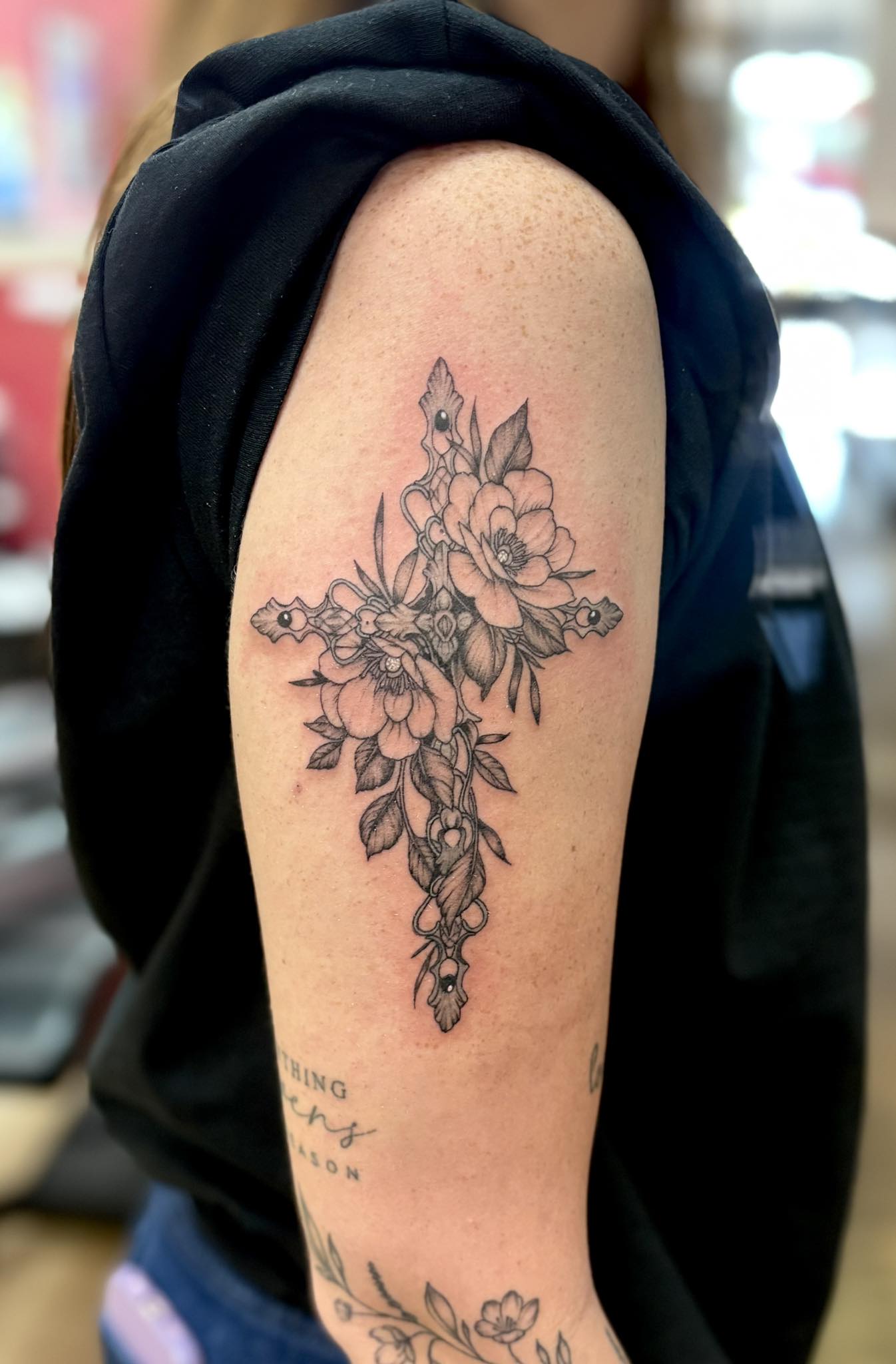 Delicate floral cross with roses and trailing vines