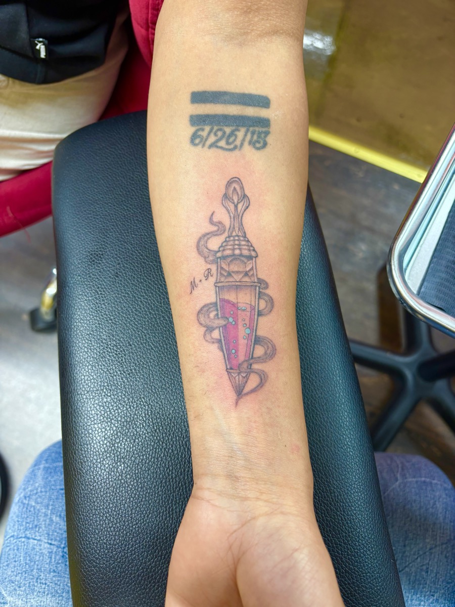 Neo-traditional dagger with pink crystal gemstone and smoke on forearm