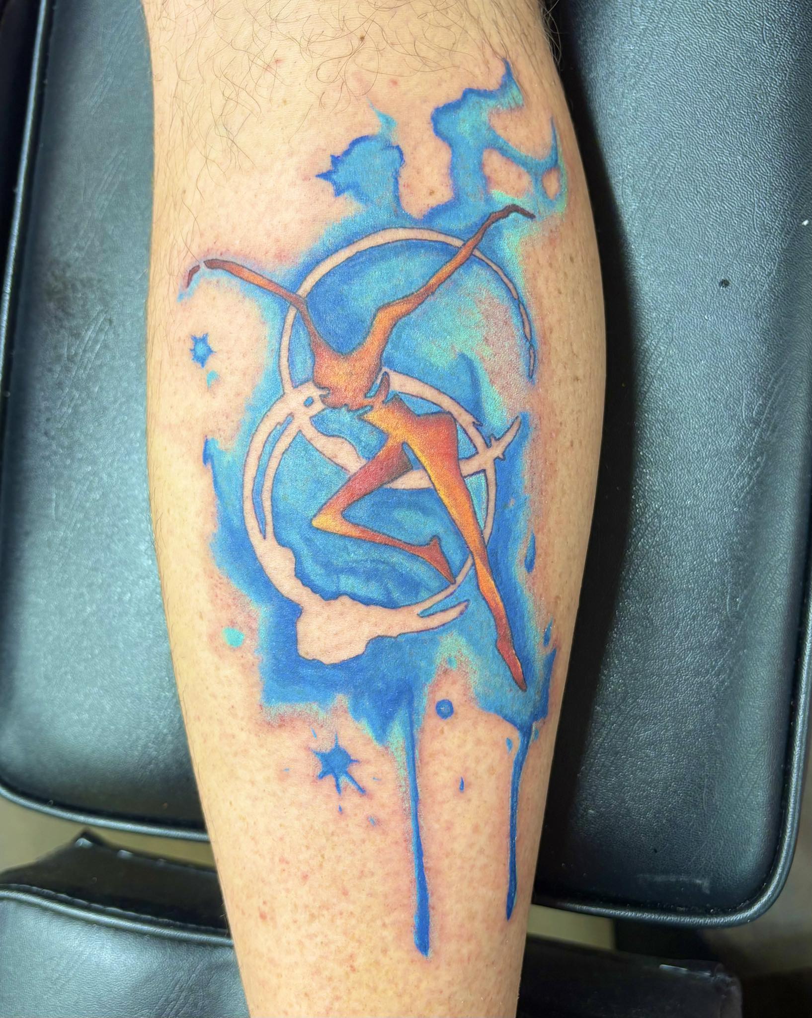 Watercolor style fire dancer silhouette with blue and orange splashes